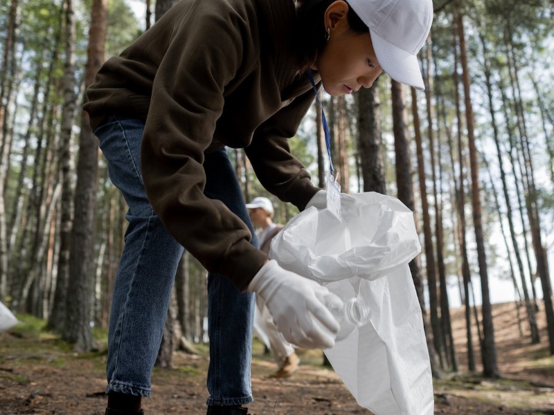 Volunteer picking up trash outdoors